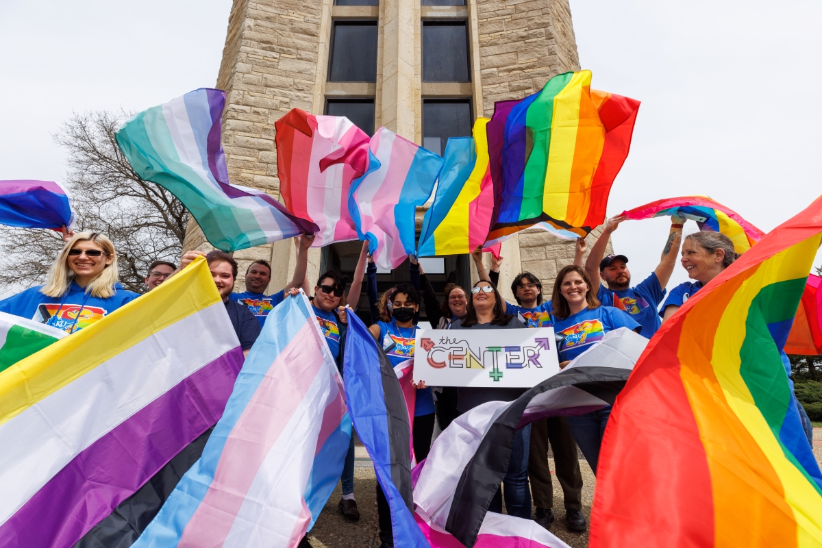 People holding various pride flags