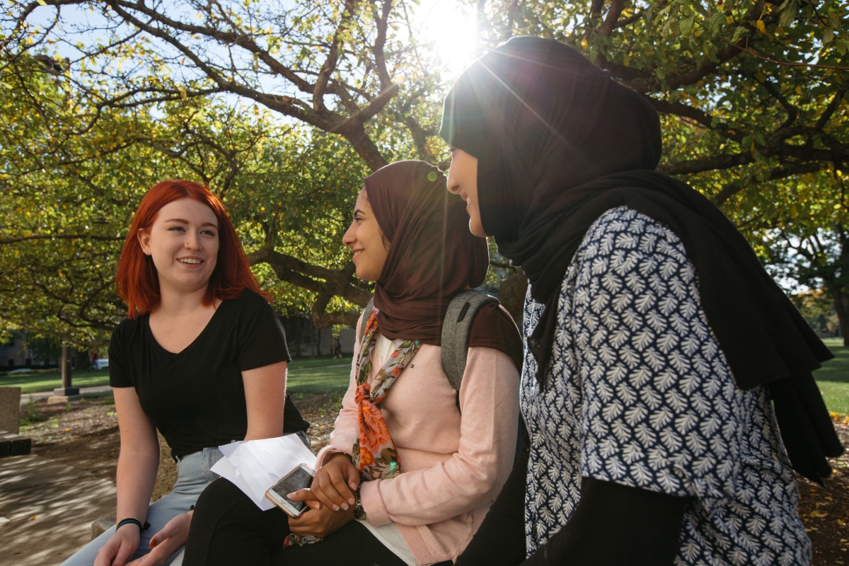 Three students sitting and talking
